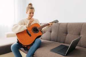 young-girl-playing-a-guitar-at-home.jpg
